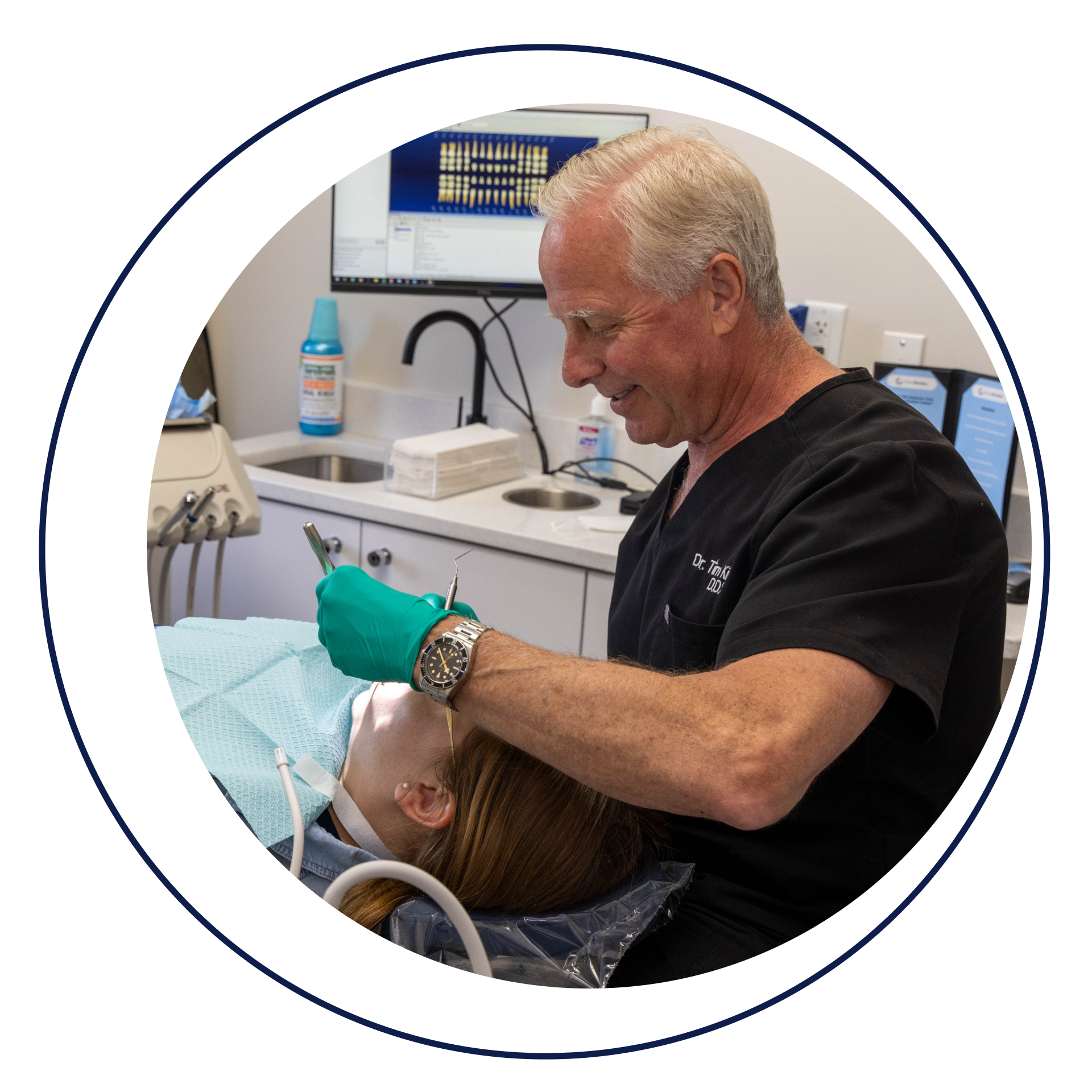 Dr. Tim performing dental procedure on patient
